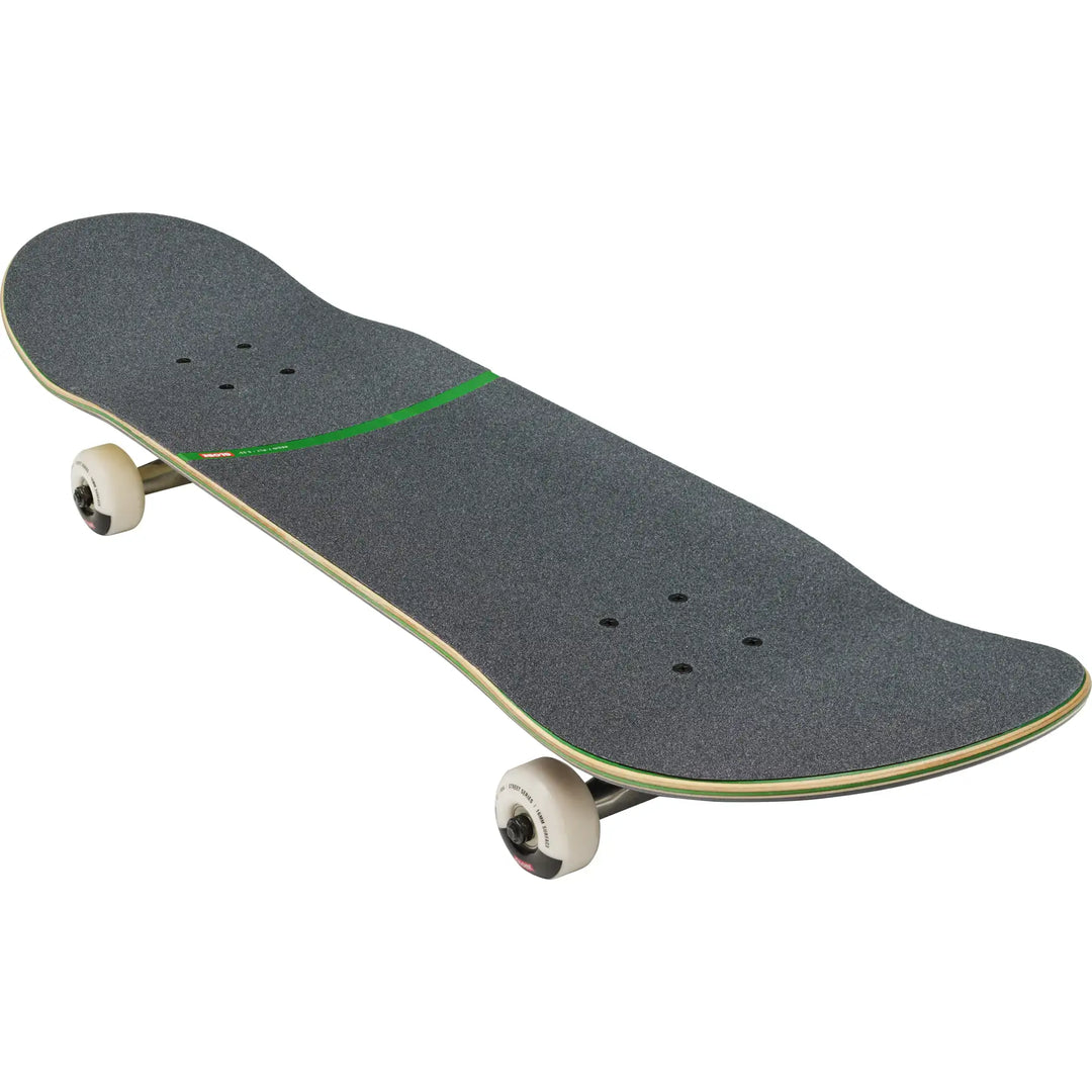 A skateboard with dark gray grip tape, a thin green stripe, and cream-colored wheels on a solid white background.